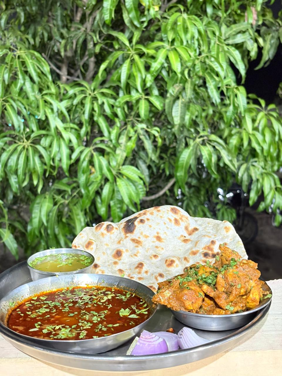 Chicken rassa thali under the mango tree